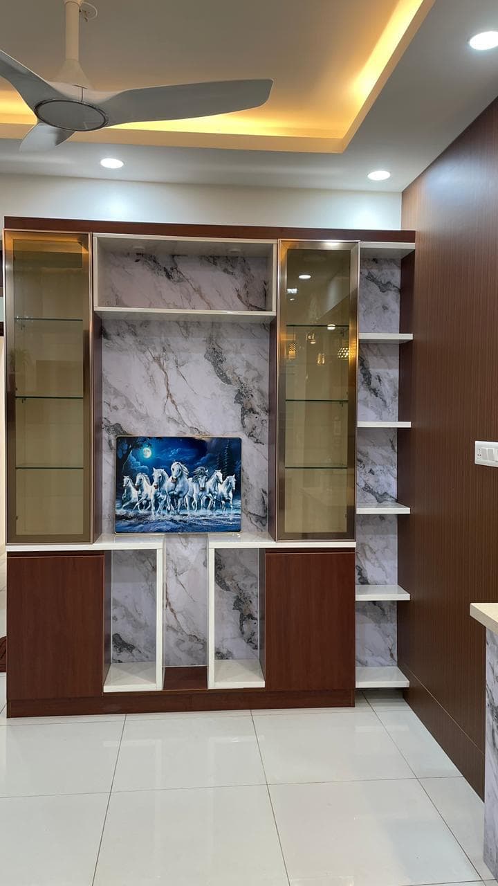 Living room TV unit with a marble-finish panel and open display shelving, by ACIPL