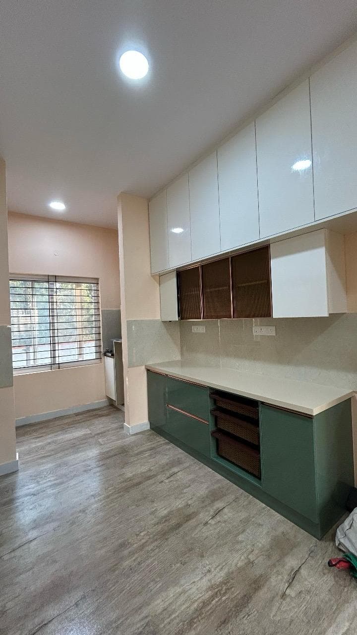 Parallel kitchen with full-height white storage and green base units, by ACIPL